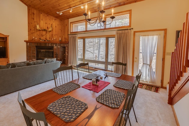 16 Riverfront Dr Unit 292, Woodstock, NH 03262 - dining area featuring light colored carpet, a notable chandelier, a brick fireplace, high vaulted ceiling, and wooden ceiling