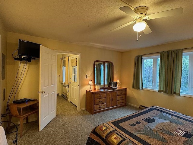 carpeted bedroom featuring baseboards, a ceiling fan, and a textured ceiling