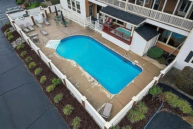 pool with fence and a patio area