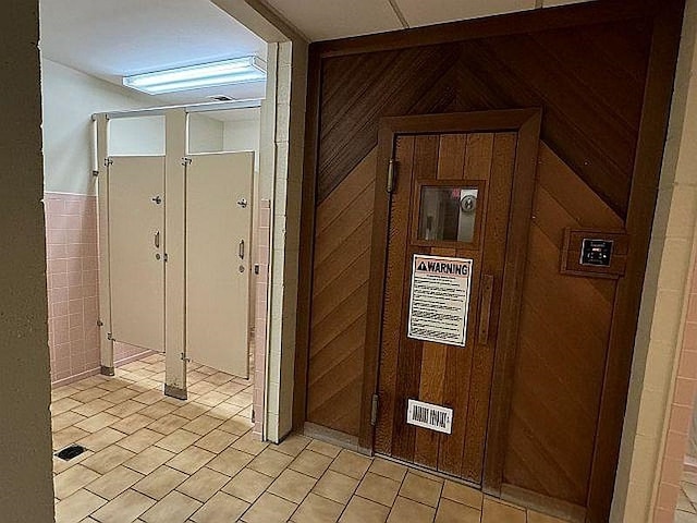 corridor featuring wood walls