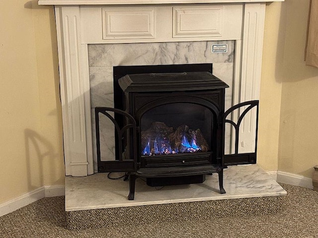 interior details featuring baseboards and a wood stove