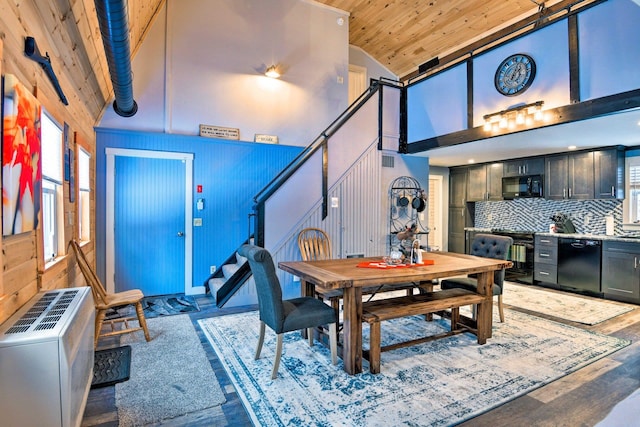 dining area featuring high vaulted ceiling, wood ceiling, stairway, and wood finished floors
