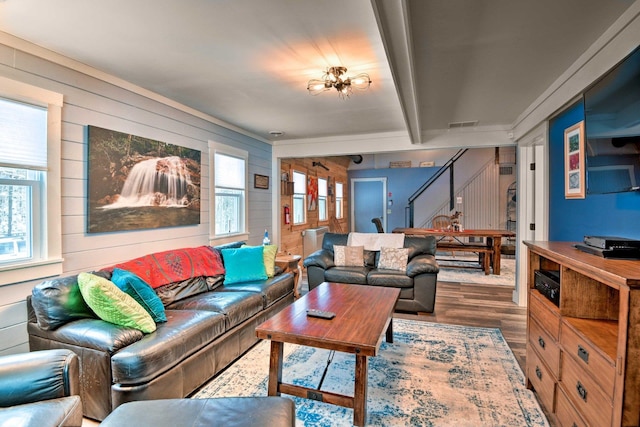 living room featuring wood walls and a healthy amount of sunlight