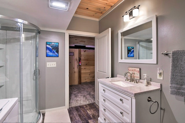 bathroom with vanity, wood finished floors, baseboards, wooden ceiling, and a stall shower