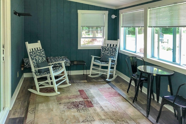 sunroom / solarium with baseboards and wood finished floors