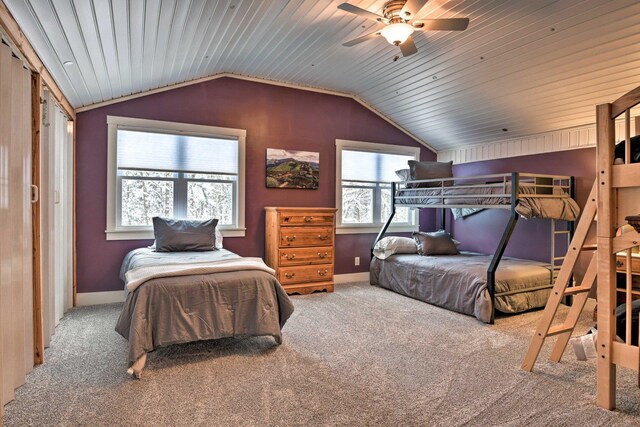 bedroom featuring baseboards, a ceiling fan, carpet flooring, and lofted ceiling