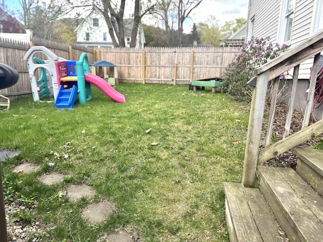 view of yard featuring a playground and a fenced backyard