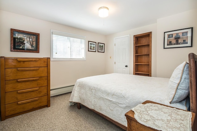 carpeted bedroom with a baseboard heating unit