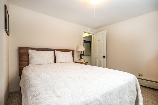 carpeted bedroom with a baseboard heating unit