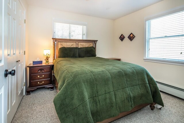 bedroom featuring carpet floors and a baseboard heating unit