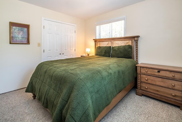 bedroom with a closet and light colored carpet