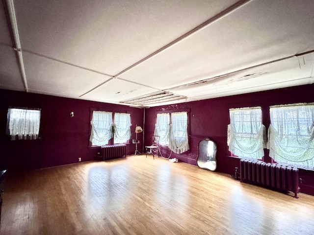 sitting room featuring wood finished floors and radiator heating unit
