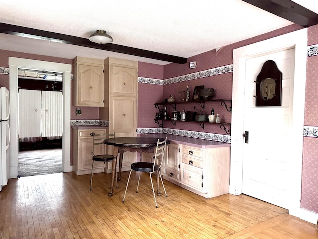 kitchen featuring freestanding refrigerator, light wood-style floors, open shelves, and wallpapered walls