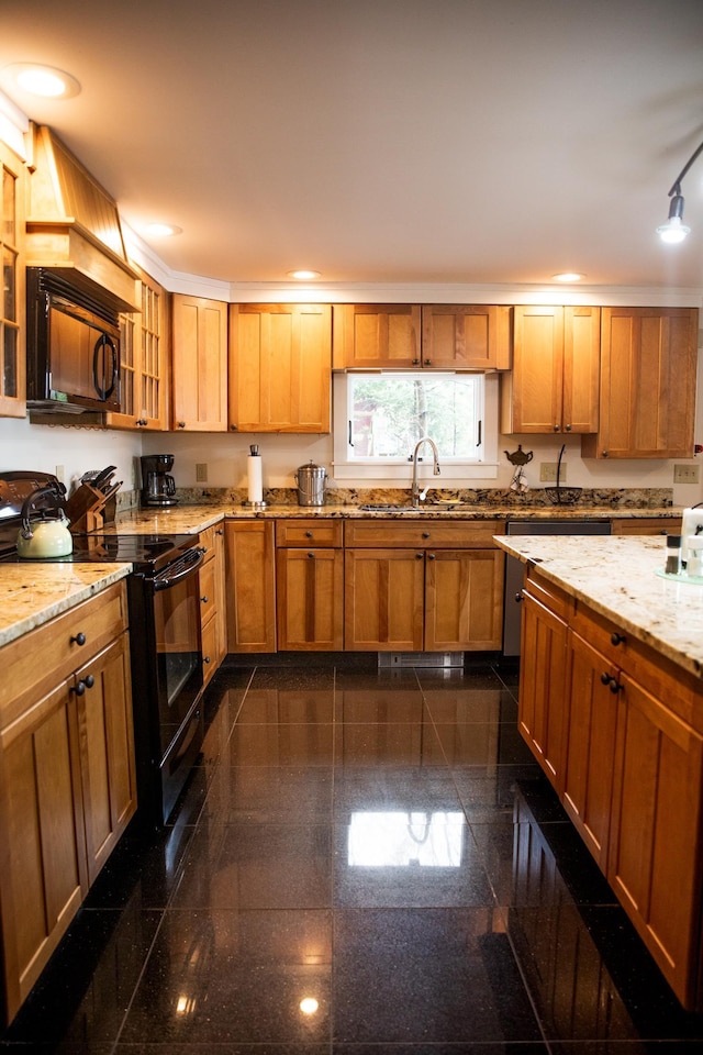 kitchen with a sink, granite finish floor, recessed lighting, glass insert cabinets, and black appliances