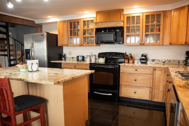 kitchen with a kitchen breakfast bar, light stone counters, glass insert cabinets, and black appliances