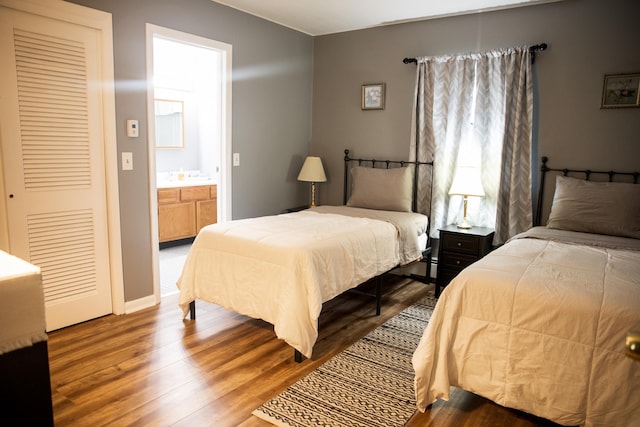 bedroom featuring baseboards and wood finished floors