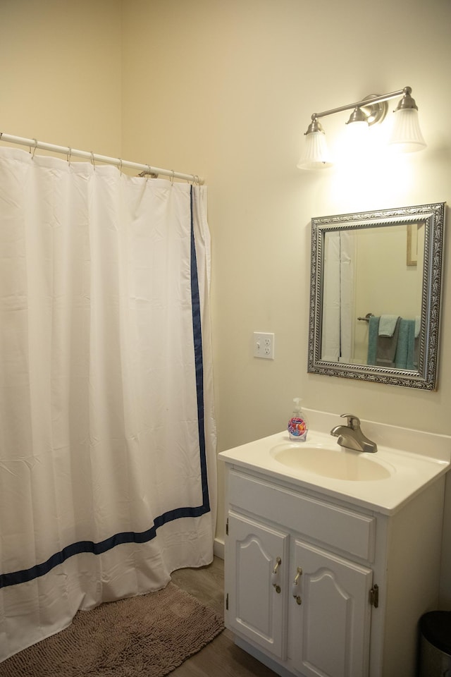 bathroom with vanity and wood finished floors