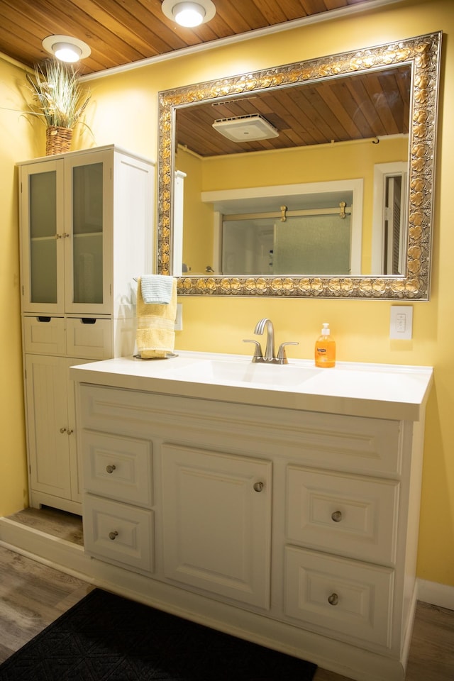 bathroom with vanity, wood ceiling, and wood finished floors
