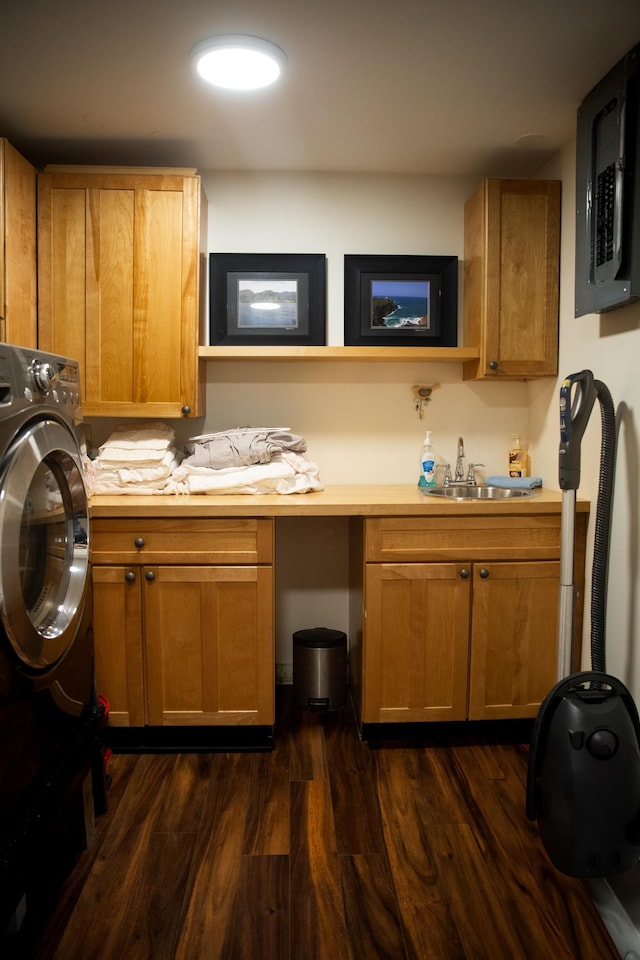 clothes washing area with cabinet space, washer / clothes dryer, a sink, and dark wood-type flooring