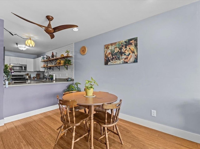 dining space featuring recessed lighting, baseboards, ceiling fan, and light wood-type flooring