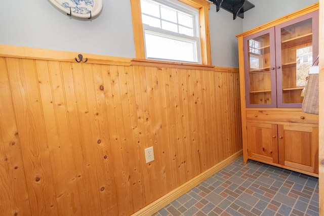 interior space featuring wood walls and wainscoting