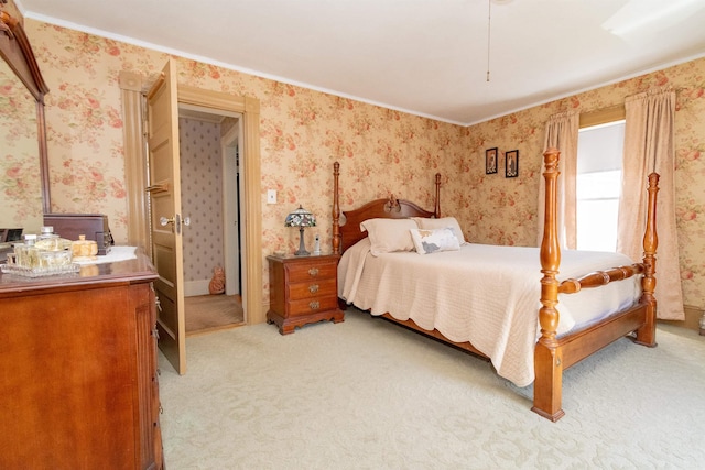 bedroom with crown molding, wallpapered walls, and light carpet