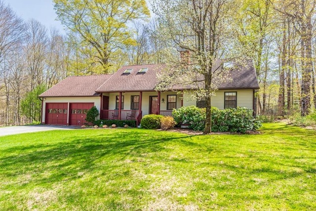 single story home featuring covered porch, a front yard, and aphalt driveway