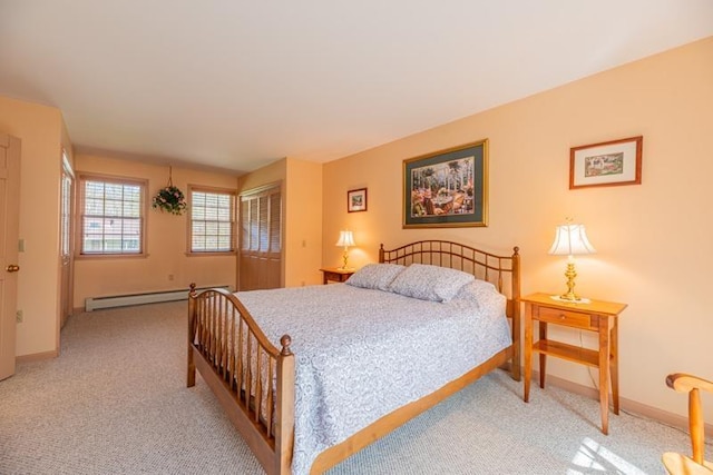 bedroom with baseboards, a baseboard radiator, and light carpet