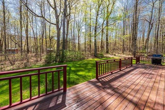 wooden deck with a yard and area for grilling