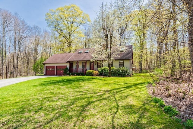 ranch-style home featuring covered porch, an attached garage, concrete driveway, and a front lawn