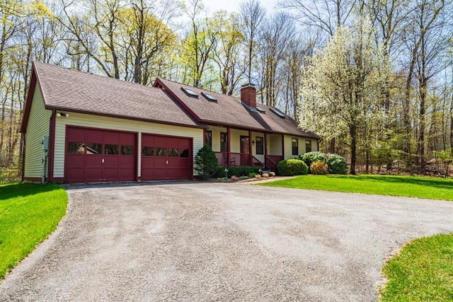 single story home with a garage, a front lawn, driveway, and a chimney