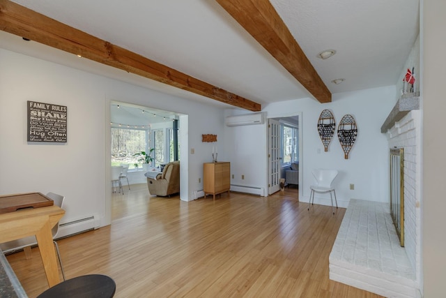 living room with beam ceiling, a wall unit AC, baseboard heating, and light wood-type flooring