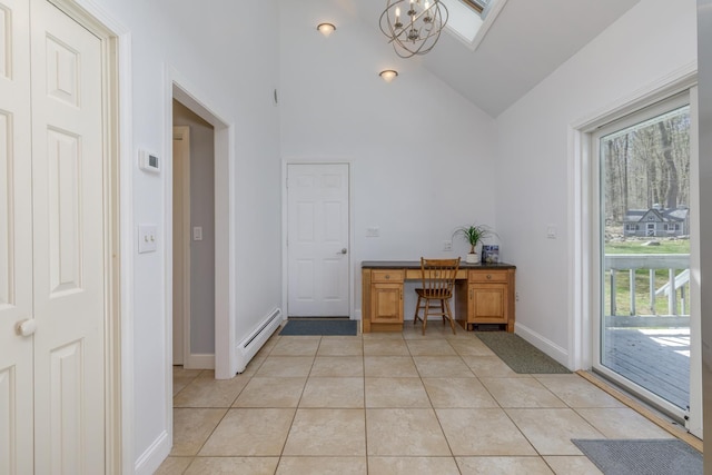 unfurnished office with a baseboard radiator, light tile patterned floors, baseboards, a chandelier, and high vaulted ceiling