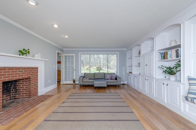 living area featuring crown molding, a fireplace, light wood-style flooring, recessed lighting, and baseboards