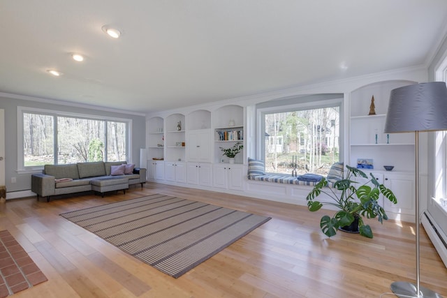 living room featuring crown molding, built in features, baseboard heating, and light wood-style floors