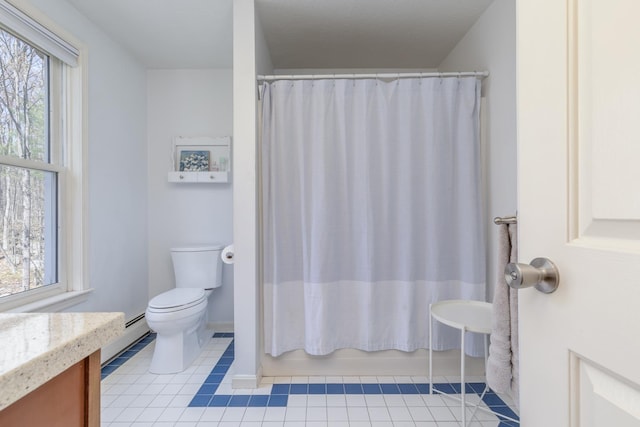 bathroom with baseboard heating, tile patterned floors, baseboards, vanity, and toilet