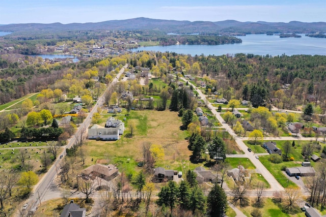 bird's eye view featuring a water and mountain view and a wooded view