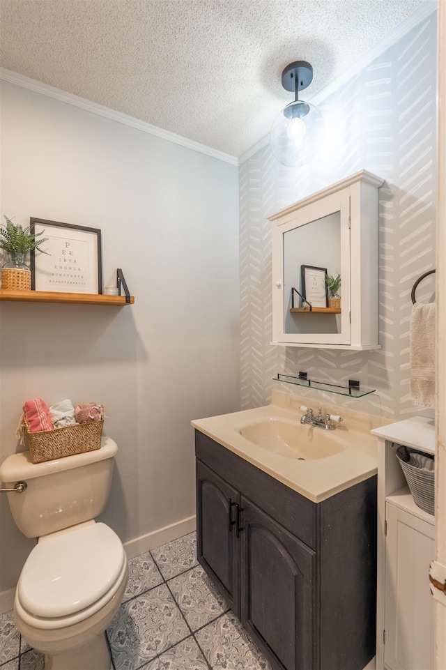 bathroom with toilet, a textured ceiling, baseboards, vanity, and ornamental molding
