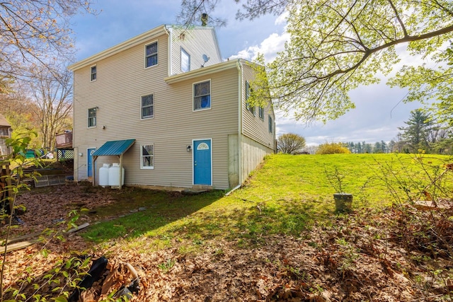 rear view of house with a lawn