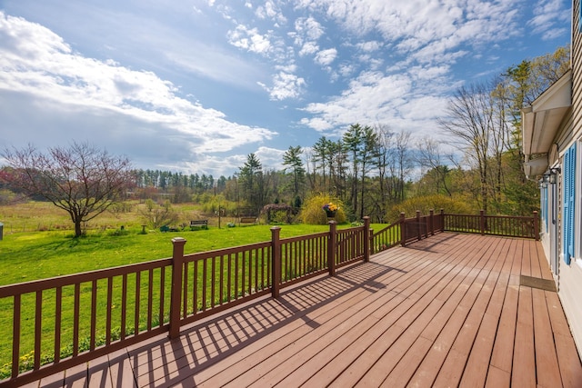 wooden terrace featuring a yard