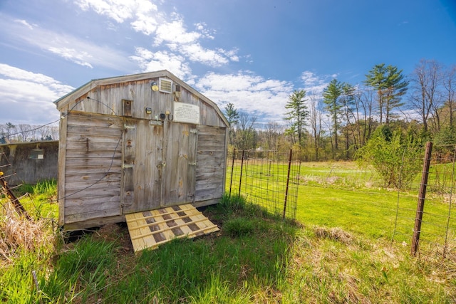 view of shed featuring fence