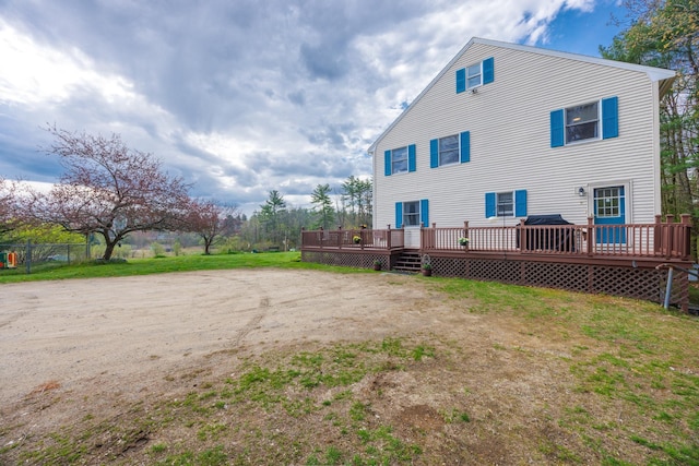 back of property featuring a wooden deck