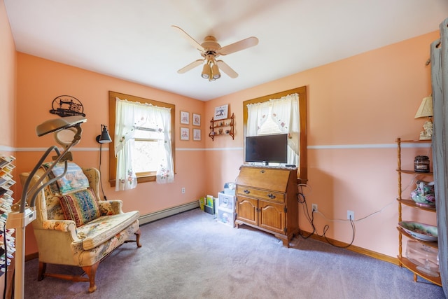 living area featuring ceiling fan, carpet, baseboards, and a baseboard heating unit