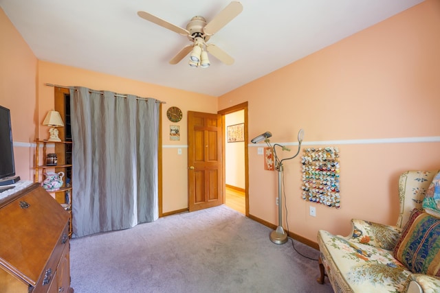 sitting room with carpet floors, a ceiling fan, and baseboards