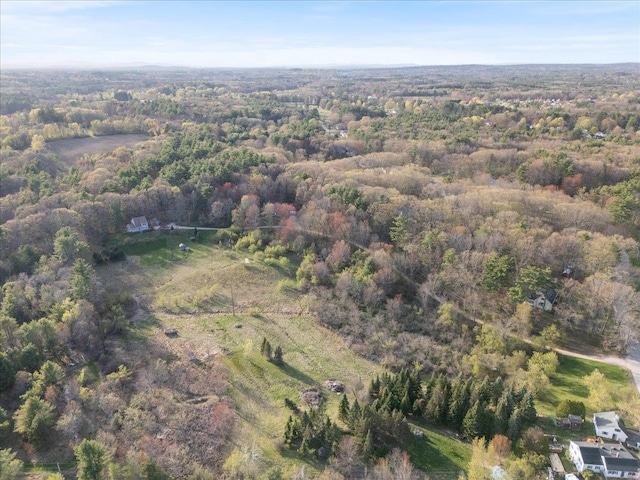 birds eye view of property with a forest view