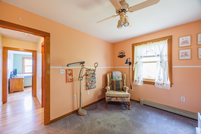 sitting room featuring a baseboard radiator, baseboards, and ceiling fan