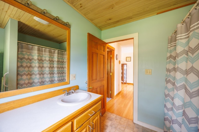 bathroom featuring wooden ceiling and vanity