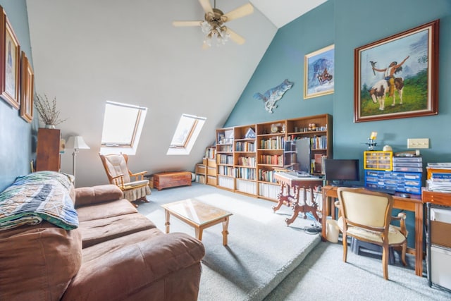 carpeted living room with a ceiling fan and vaulted ceiling with skylight