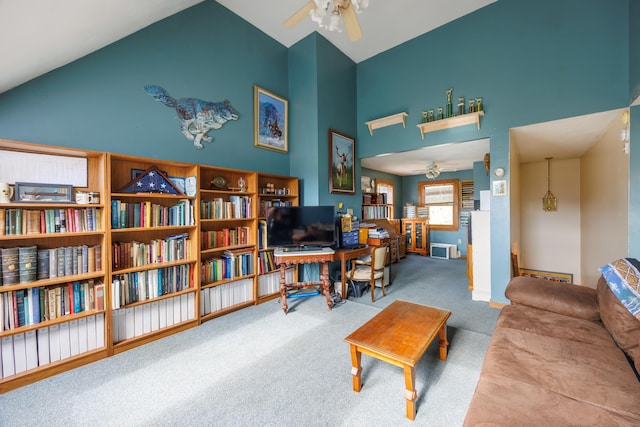 living area featuring high vaulted ceiling, carpet floors, a ceiling fan, and baseboards