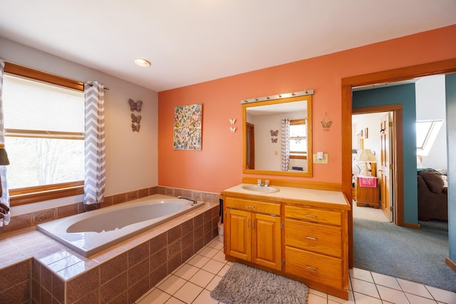 ensuite bathroom featuring ensuite bathroom, tile patterned floors, vanity, and a garden tub